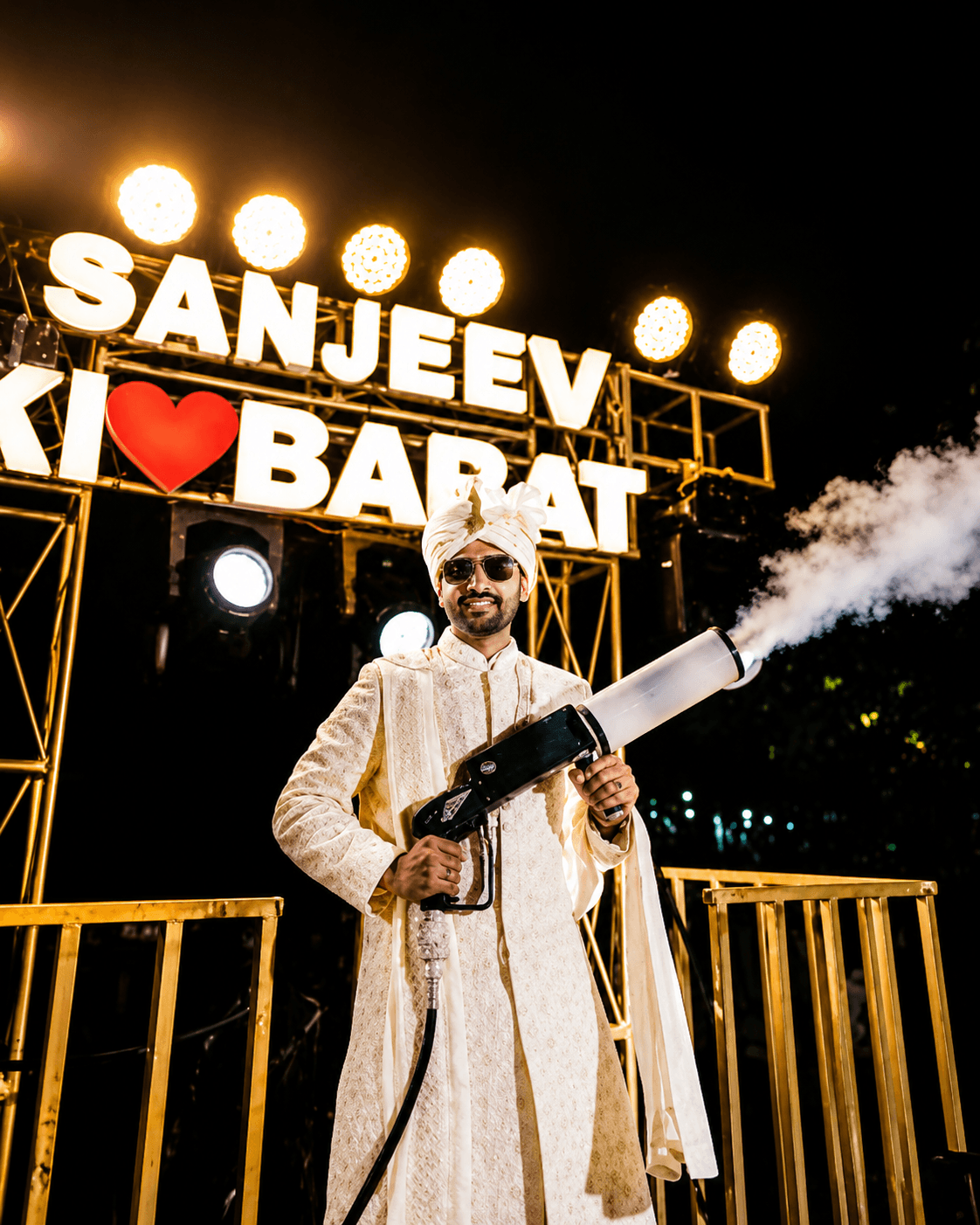 Groom celebrating beside a personalised Baraat installation