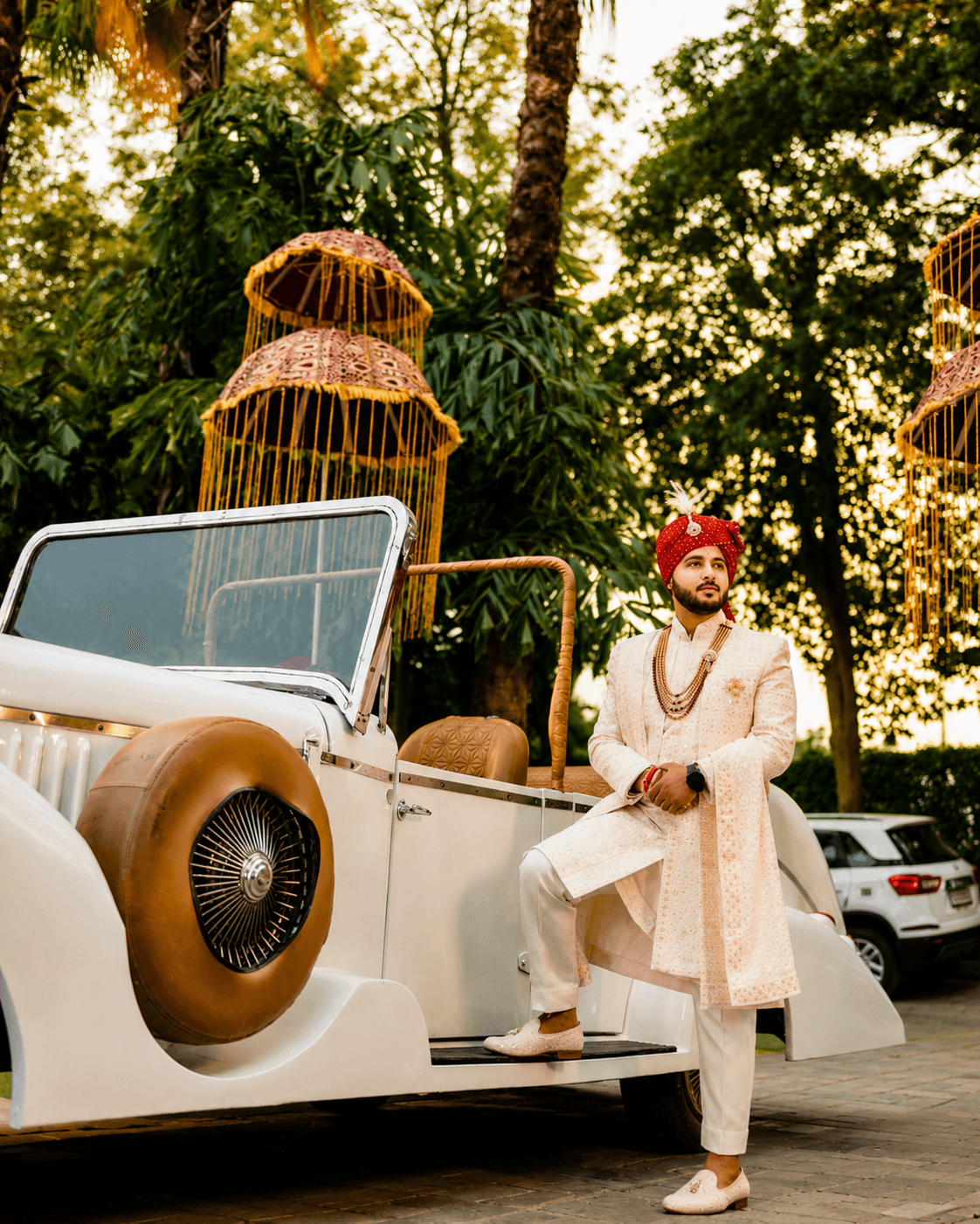 Groom arriving in a decorated vintage car
